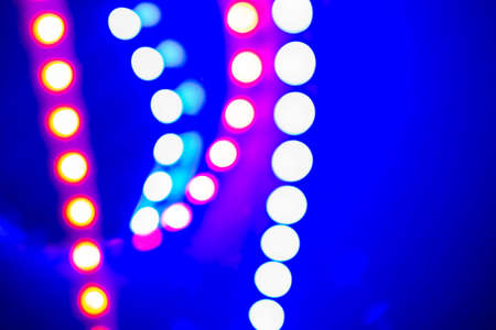 Purple blue neon bokeh lights and reflections. Festive Abstract background of 80s colors.