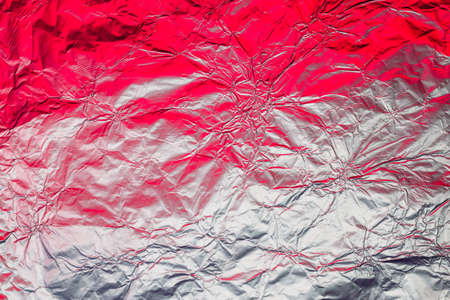 Red white metallic  made of neon lights foil. Trendy duotone texture.の写真素材