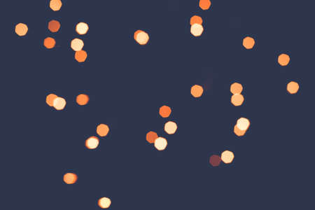 Abstract scattering of golden lights on a dark