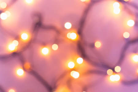 Christmas or party concept. Golden bokeh lights on blurred pinkの写真素材