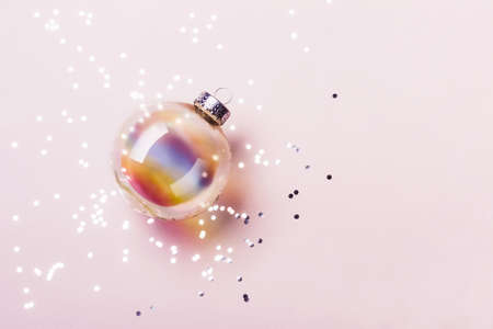 Christmas transparent holographic ball with silver confetti. Christmas concept.
