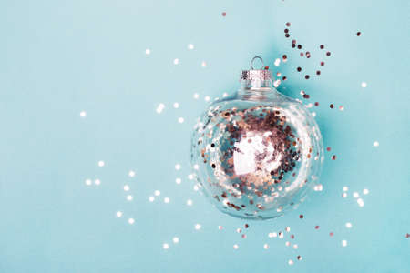 Christmas transparent ball with silver confetti on blueの写真素材
