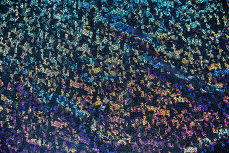 Dark fabric with folds and holographic elements.