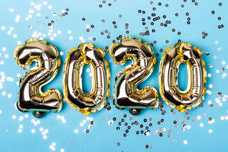 Numbers 2020 made from foil balloons on blue sparkles
