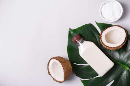 Coconut cosmetic product and tropical leaves.の写真素材