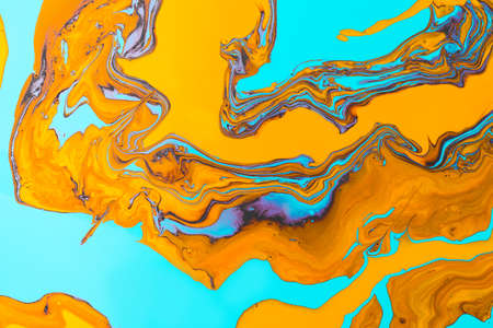 Acrylic Fluid Art. Orange flame curls and waves on turquoise