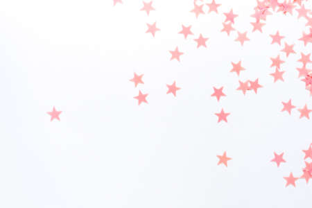 Pastel pink confetti stars on a white background. Holiday Party Concept.の写真素材