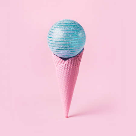 Christmas ice cream cone and blue ball. Minimal holiday concept.