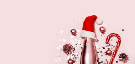Monochrome Christmas banner. Golden champagne in Santa hat, candy cane and sparkles.の写真素材