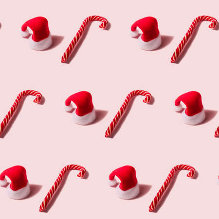 Trendy Christmas seamless texture with Santa Claus hat and candy cane. Modern christmas design.の写真素材