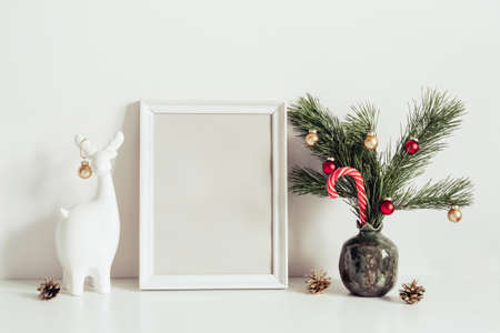 Minimalist interior decoration for Christmas. White Composition with little Christmas tree and deer....