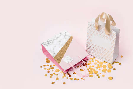 Paper shopping bag and trendy hexagonal sparkles on pink