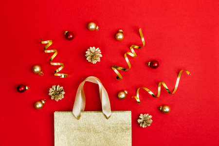 Golden Paper shopping bag, cones and balls on redの写真素材