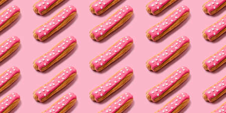 Seamless food creative texture or background. Eclairs pattern with pink icing and stars sprinkled on pink background.の写真素材