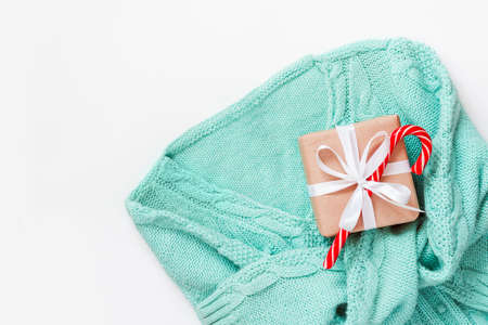 Mint Green pullover with gift box zero waste decorated on white background. Holiday concept.の写真素材