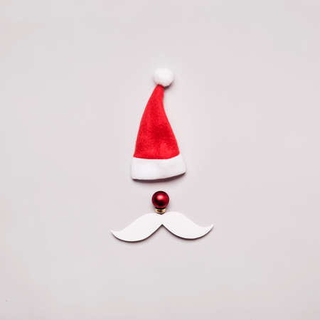 Creative Santa Claus portrait of hat, ball and cut out paper mustache.の写真素材