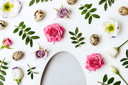 Egg shaped hole. Creative layout with floral pattern and quail eggs. Happy easter concept.の写真素材