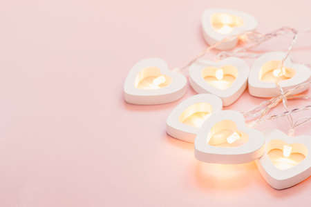 Valentine's Day Card. Delicate pink background with heart garland. Valentine's day or wedding party decor.の写真素材