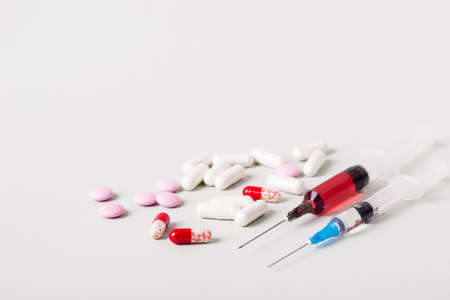 Medicine treatment concept. Various pills and syringes with medicine. Copy space.の写真素材
