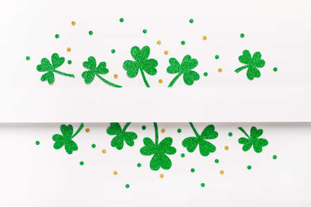 Green glitter shamrocks pattern on whiteの写真素材