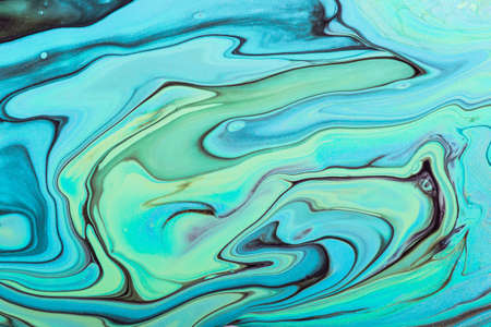 Fluid Art. Abstract marble background or texture. Beautiful blue and green waves with black veins and gold particles.の写真素材