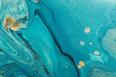 Beautiful blue waves with black veins and gold particles. Fluid Art. Abstract marble background or...