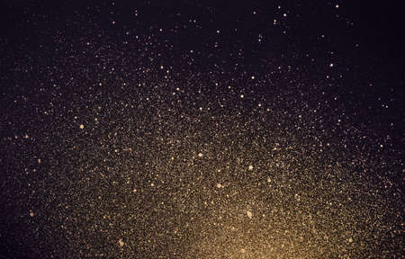 Festive background with golden shiny paint splashes. Abstract cosmos.