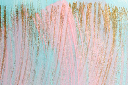 Pink and gold paint brush strokes on blueの写真素材