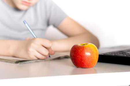 Distance learning at home. Schoolboy sitting at laptop and studying. Online education concept. Social distance during quarantine.の写真素材