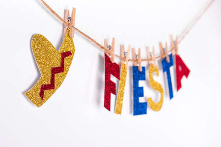 Fiesta word and sombrero made of shiny paper on pins.の写真素材