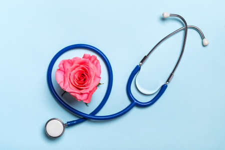 Beautiful heart rose and stethoscope on blue