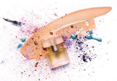 Beauty concept with abstract strokes of cosmetic products. Smudged makeup foundation, broken shadows, sparkles and perfumes on white background.の写真素材