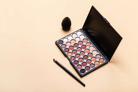 Eye shadow palette, makeup brush and sponge. Minimal beauty cosmetics layout, isometric view.