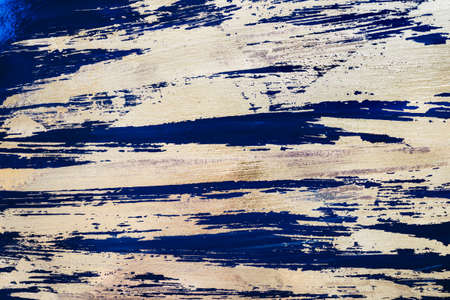 Gold potal background or texture. Abstract shining brush strokes on blue.