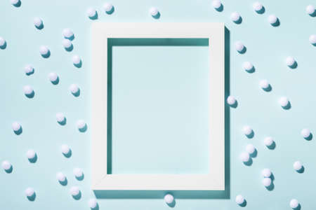 Minimal Christmas background composition with snowballs and frame, copy space.