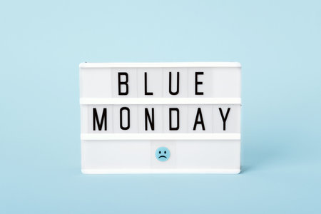Light board with Blue monday text and sad face on blueの写真素材