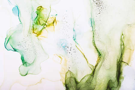 Watercolor alcohol ink swirls. Transparent waves and swirls in green colors. Delicate pastel spots...