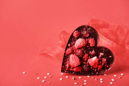 Chocolate valentine heart. Handmade chocolate with freeze-dried berries. Love symbol on red...