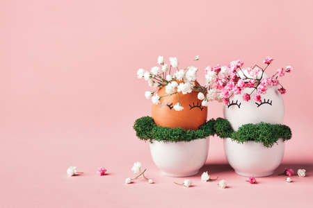 White and black Easter eggs with natural flowers wreath. Zero Waste Easter Concept. Racial Equality symbolの写真素材