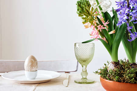 Easter table setting with natural Hyacinths flowers in wooden bowl. Zero Waste Easter, home festive...