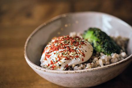 Healthy vegetarian salad. Warm buckwheat groats, poached egg and avocado sauce close-up. Selective focusの写真素材