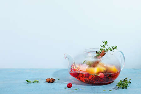 Immunity boosting drink. Winter Tea with cranberries, orange, hibiscus and spices in glass teapotの写真素材