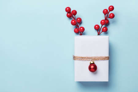 Christmas Gift box packed in paper, decorated with bauble and twine. Christmas Gift Wrapping Idea