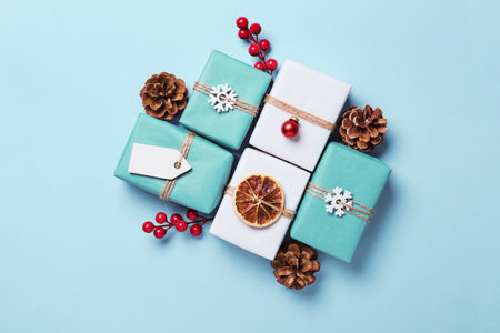 Gifts boxes packed in paper, decorated with baubles and twine. Eco Christmas Gift Wrapping