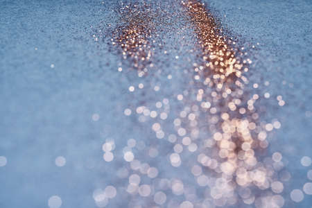 Blue festive background. Abstract scattering of gold sparkles. Christmas Winter backdrop, selective focusの写真素材