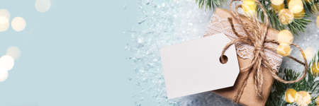 Gift box packed in paper with lace and twine. Eco Christmas decor, banner formatの写真素材