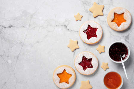 Traditional Linzer cookies with red and yellow jam. Cooking Christmas background