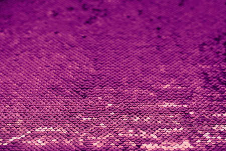 Shiny background with coral and violet sequins colors 2022. Abstract festive sparkling backgroundの写真素材