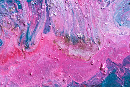Fluid Art. Embossed strokes and drips of pink paint. Marble effect background or textureの写真素材