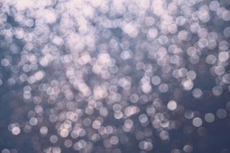 Festive Blue background of silver glitter lights. Winter blurred abstractionの写真素材